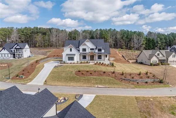 an aerial view of a house with a yard