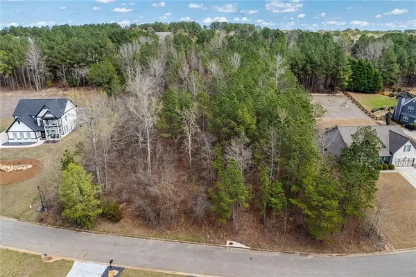 an aerial view of a house with a yard
