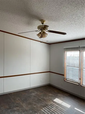 a view of a livingroom with a ceiling fan and window