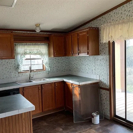 a kitchen with a sink and cabinets