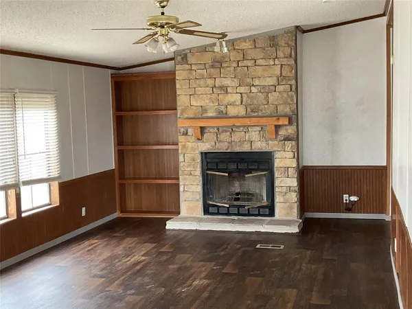 a living room with a fireplace and a window