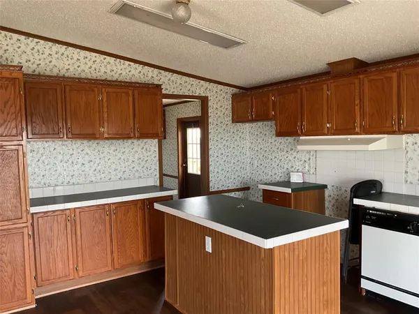 a kitchen that has a sink and a stove
