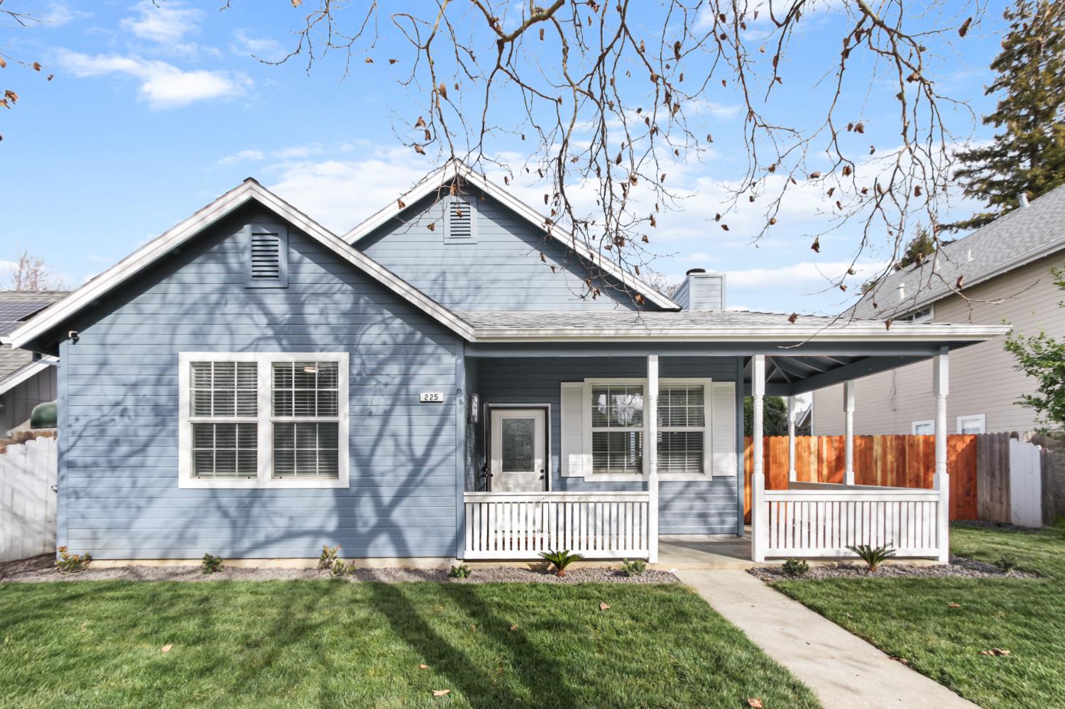 225 Creekside Way Winters, CA 95694 - Photo 1 of 56 a front view of a house with a yard and potted plants
