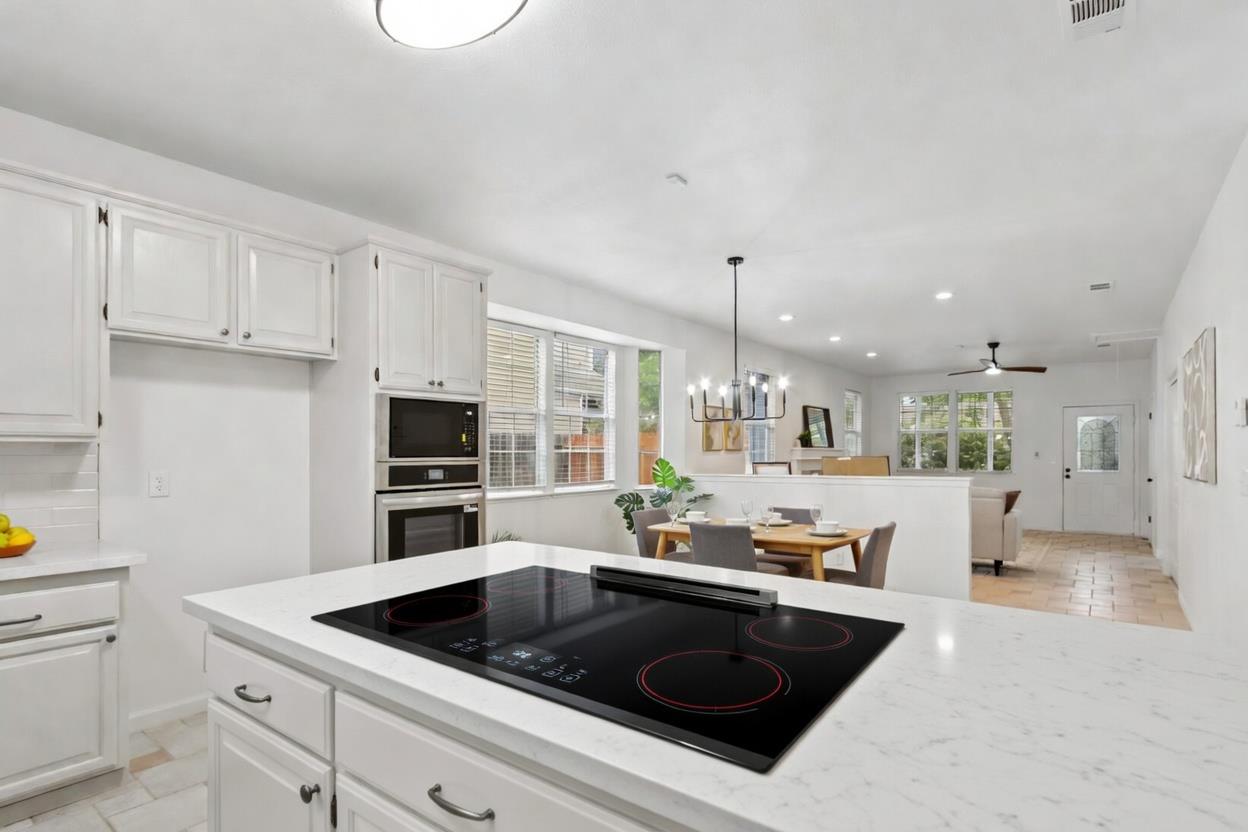225 Creekside Way Winters, CA 95694 - Photo 11 of 56 a kitchen with stainless steel appliances a sink a stove a microwave and cabinets