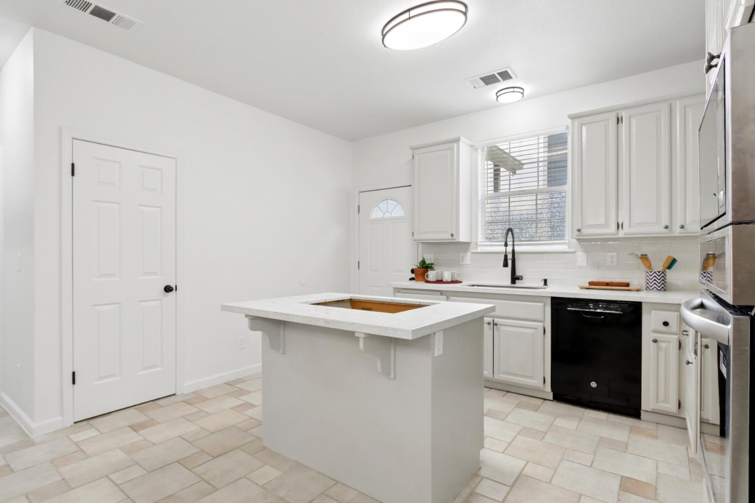 225 Creekside Way Winters, CA 95694 - Photo 13 of 56 a kitchen with a sink stove and cabinets