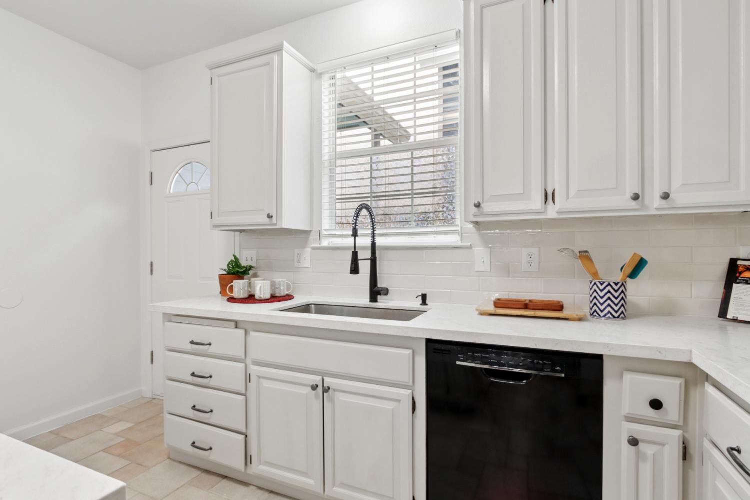 225 Creekside Way Winters, CA 95694 - Photo 14 of 56 a kitchen with stainless steel appliances white cabinets and a window