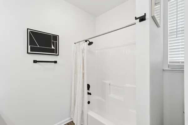 a bathroom with a granite countertop sink a toilet and shower