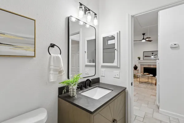 a kitchen with a stove and wooden floor