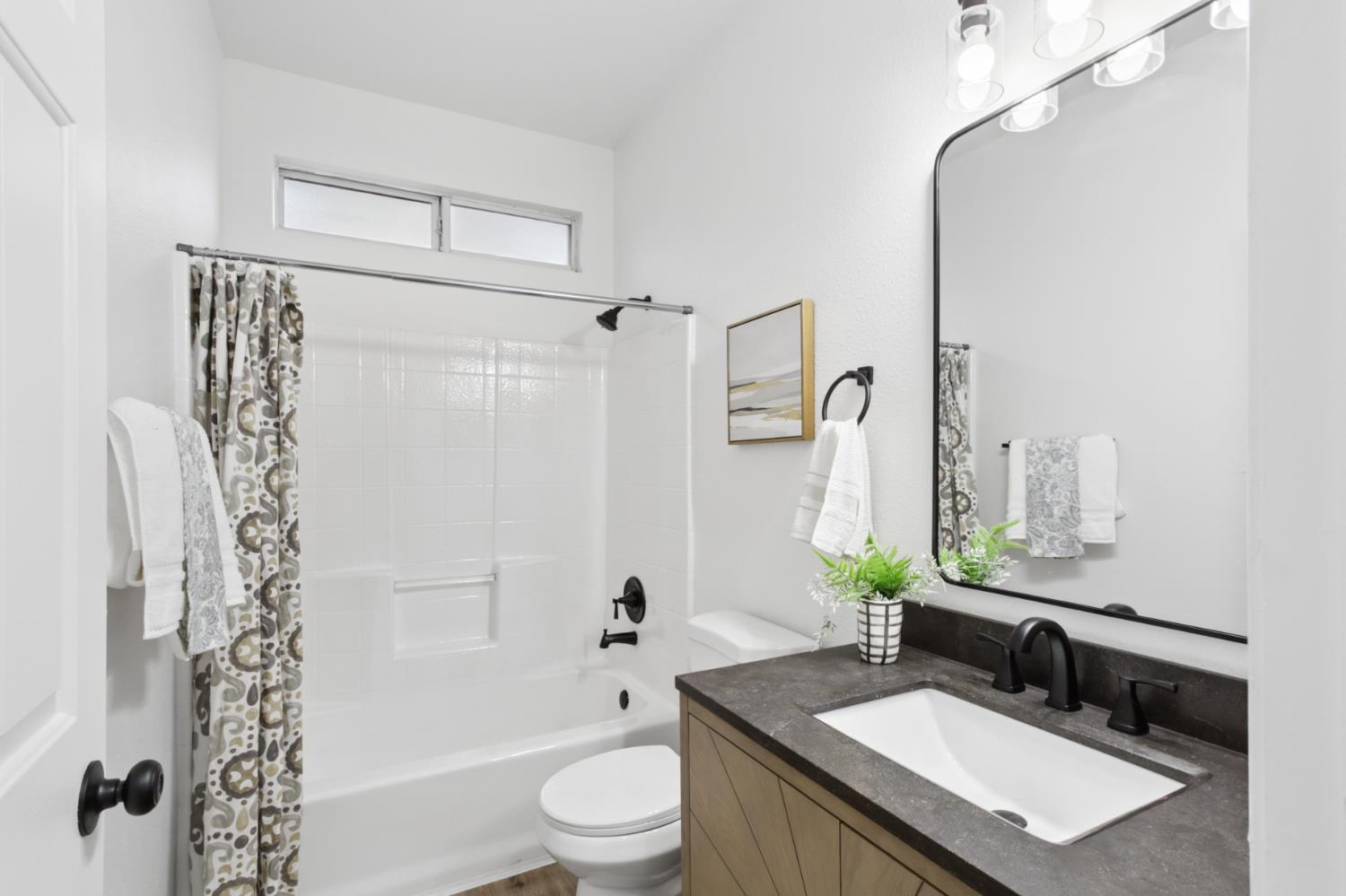 225 Creekside Way Winters, CA 95694 - Photo 25 of 56 a bathroom with a granite countertop sink toilet and shower