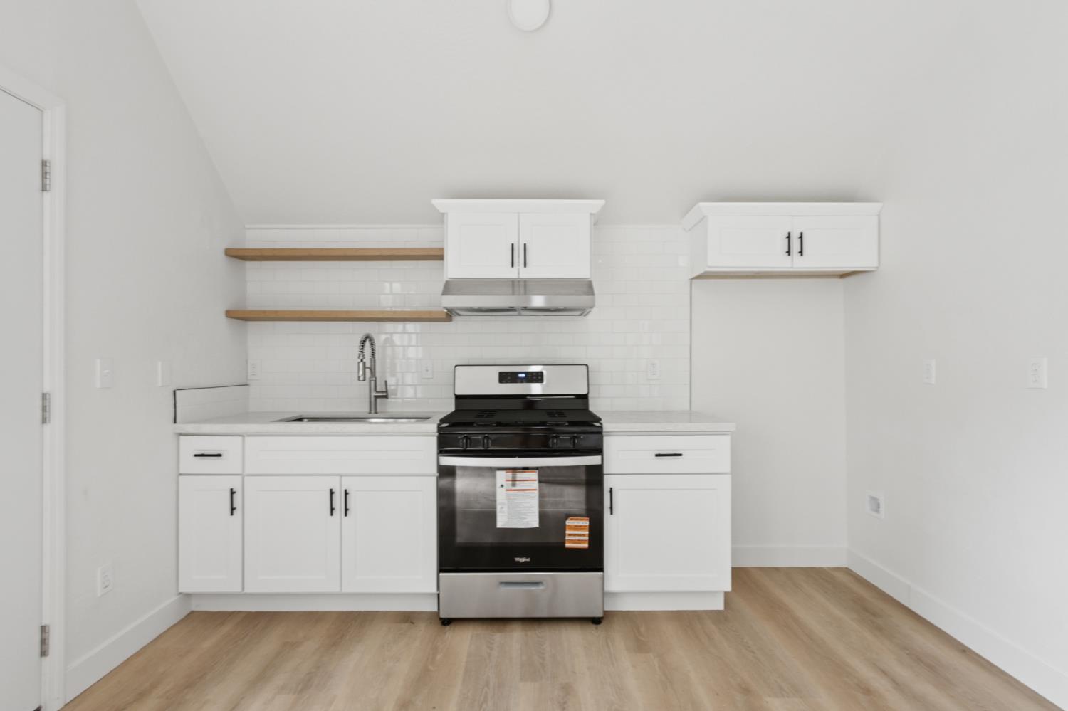 225 Creekside Way Winters, CA 95694 - Photo 29 of 56 a kitchen with a stove and wooden floor