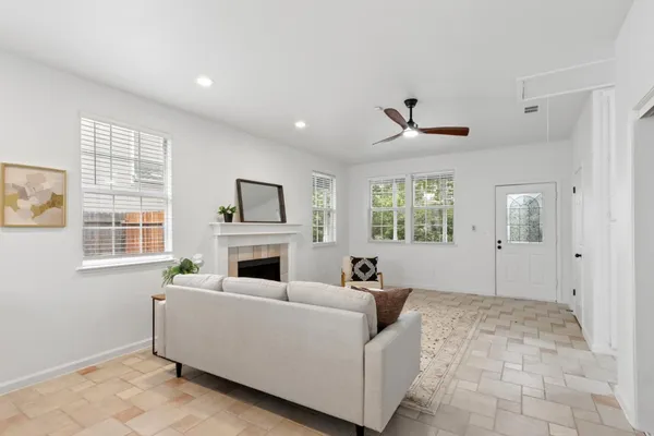 a living room with furniture fireplace and window