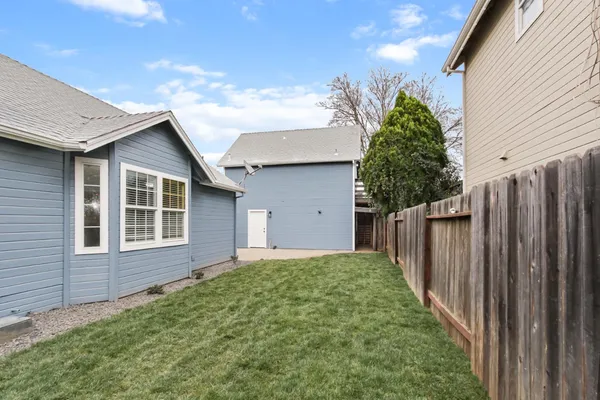 a view of a house with a yard and garage