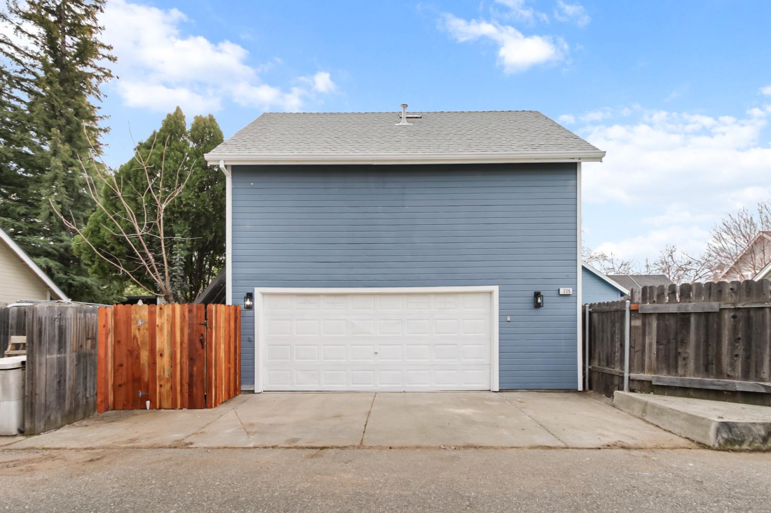 225 Creekside Way Winters, CA 95694 - Photo 53 of 56 a brick house with a small yard and wooden fence
