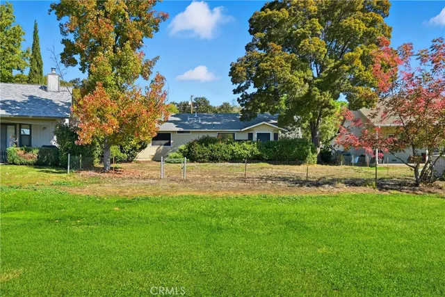 a view of backyard of house and car parked