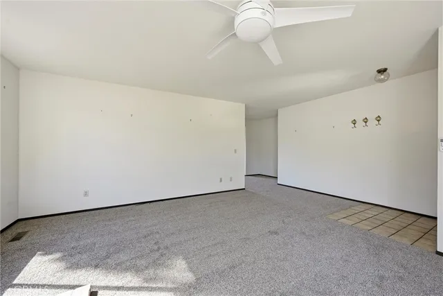 a view of a room with a projector and white walls