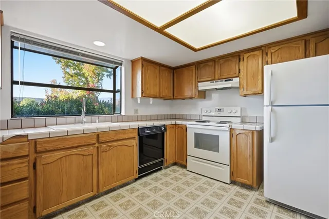 a kitchen with a stove a sink and a refrigerator