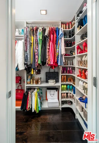 a view of walk in closet with clothes