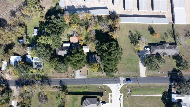 an aerial view of a house with a yard basket ball court and outdoor seating