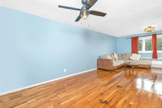a view of a room with wooden floor and lounge chair