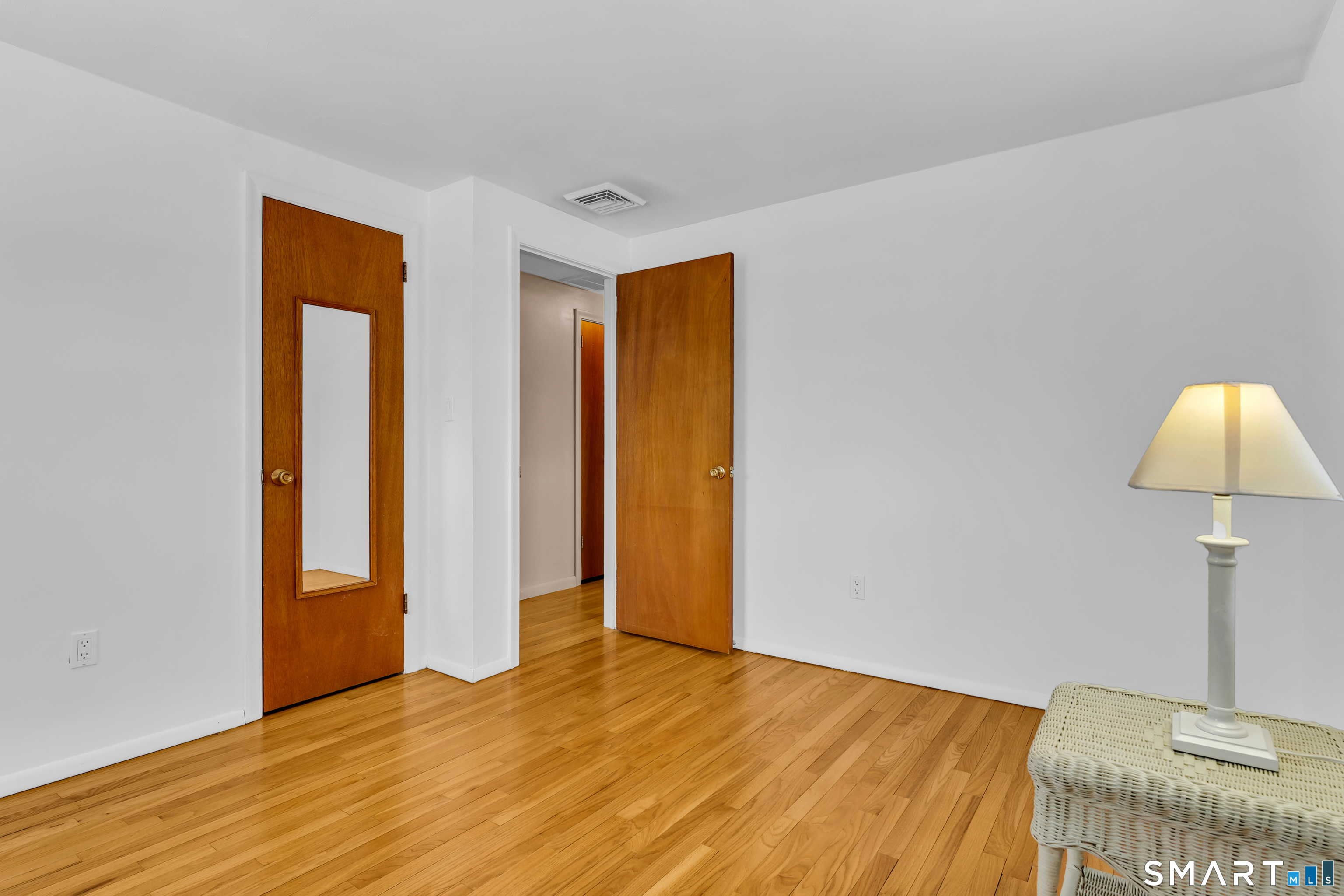 204 Parker Farms Road Wallingford, CT 06492 - Photo 27 of 39 a view of an empty room with window and wooden floor