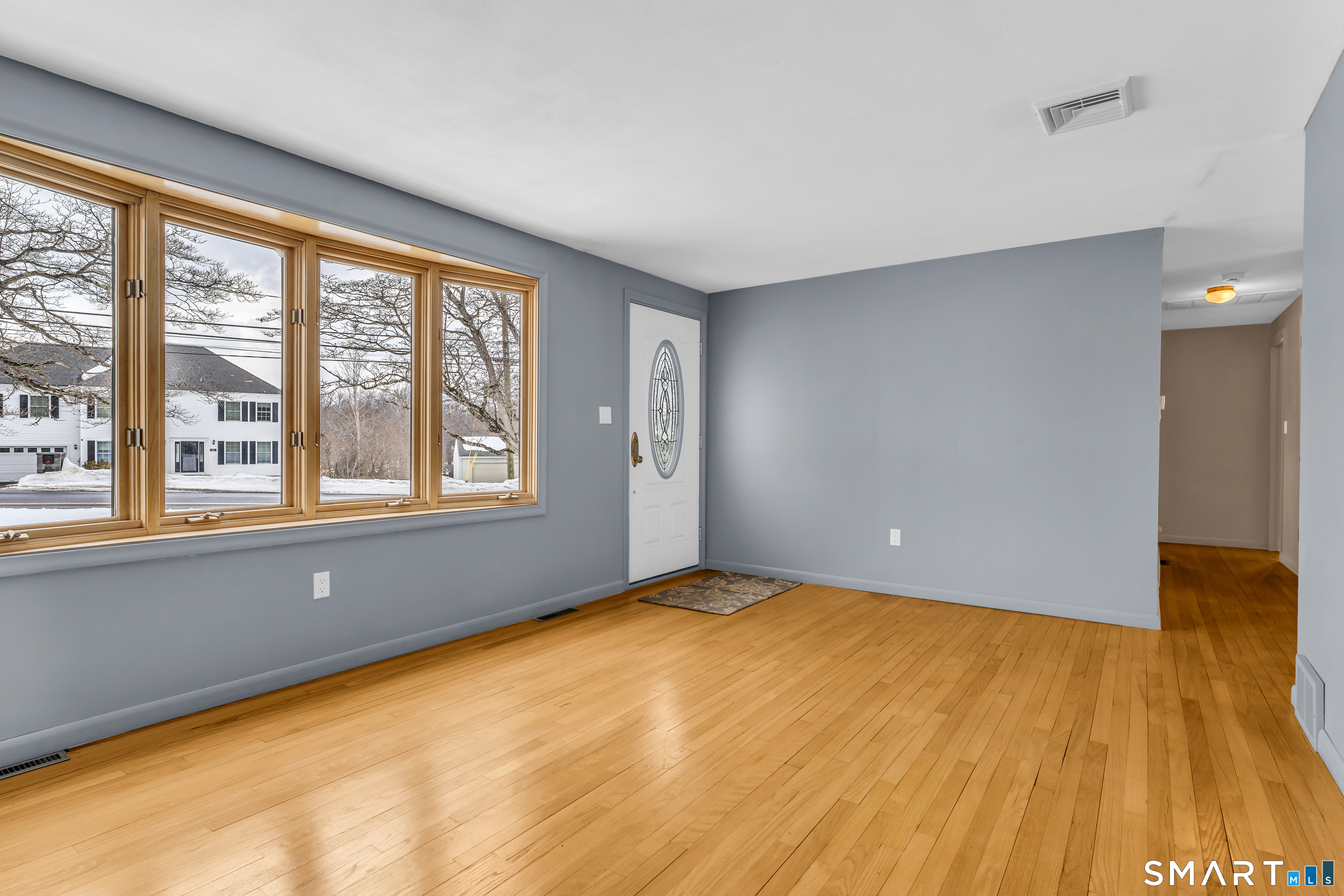 204 Parker Farms Road Wallingford, CT 06492 - Photo 4 of 39 a view of an empty room with wooden floor and a window