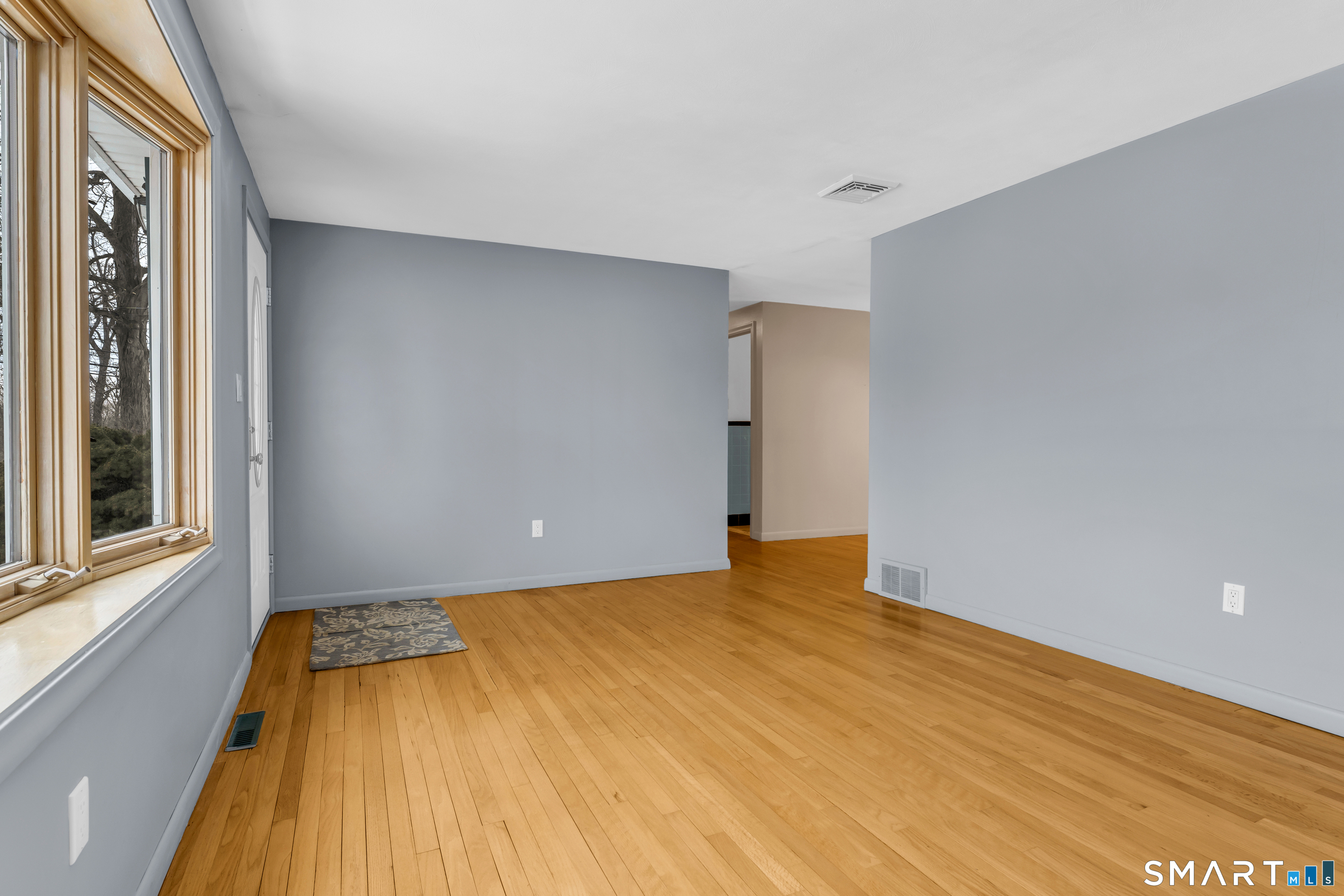 204 Parker Farms Road Wallingford, CT 06492 - Photo 5 of 39 a view of a room with a wooden floor and a window