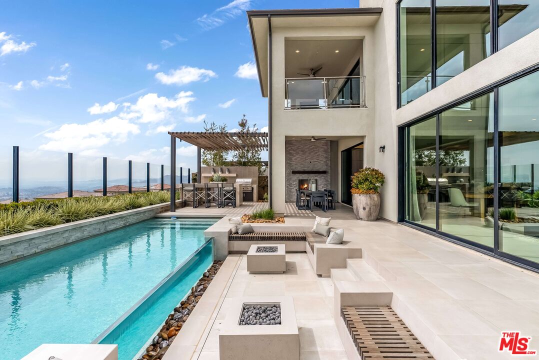 20378 Marlow Lane Porter Ranch, CA 91326 - Photo 40 of 52 a view of a patio with swimming pool table and chairs