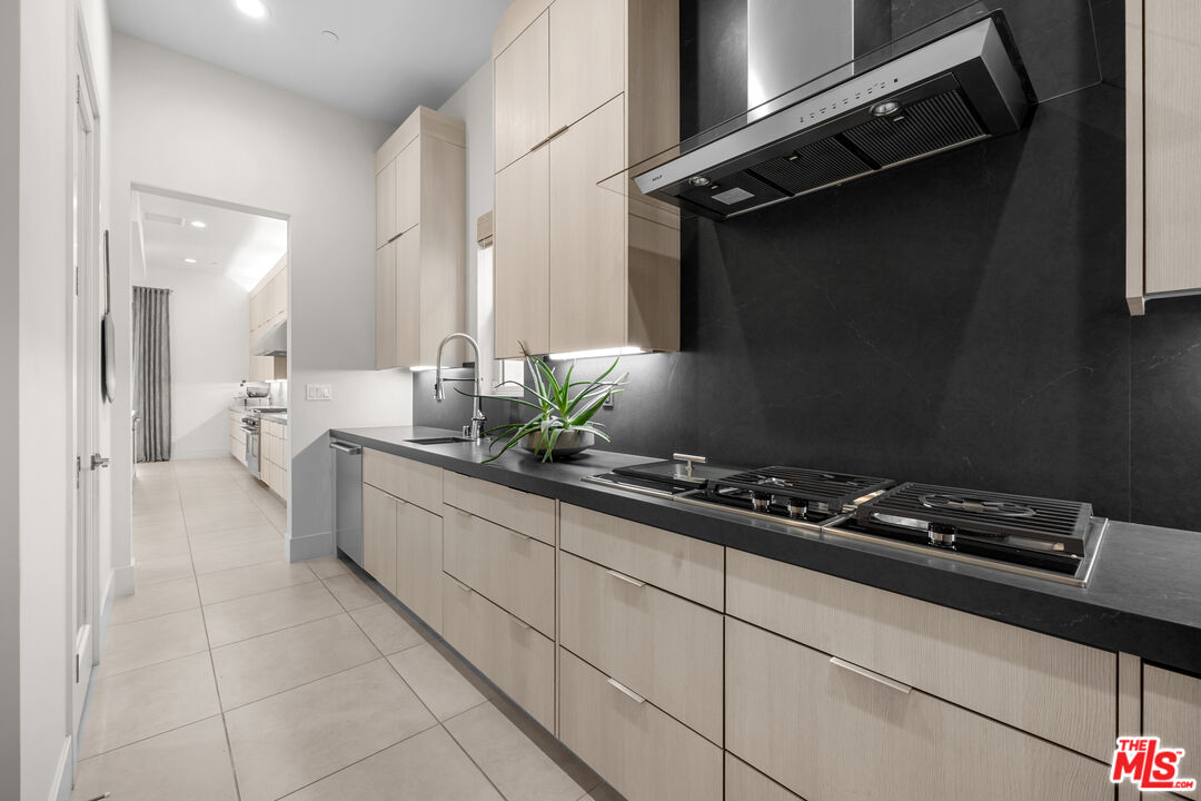 20378 Marlow Lane Porter Ranch, CA 91326 - Photo 7 of 52 a kitchen with stainless steel appliances a sink stove and cabinets