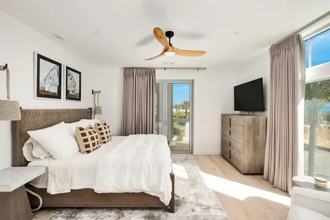 a bedroom with a large bed and a flat screen tv