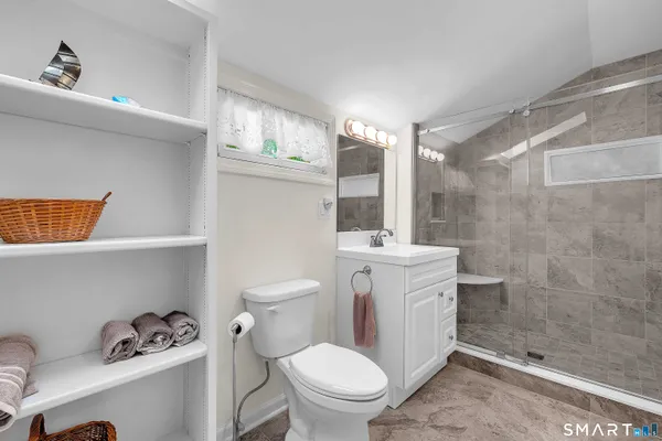a bathroom with a toilet a sink and a shower