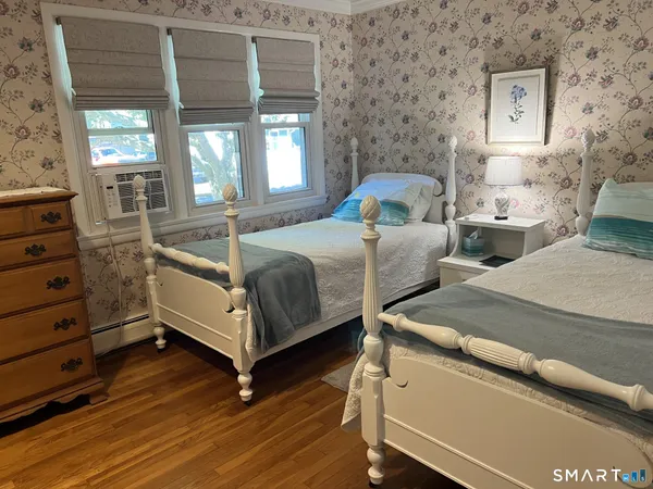 a bed room with two beds and painted walls