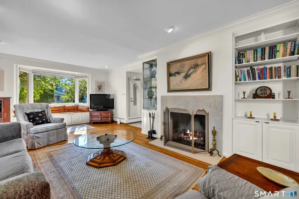 a living room with furniture fireplace and window