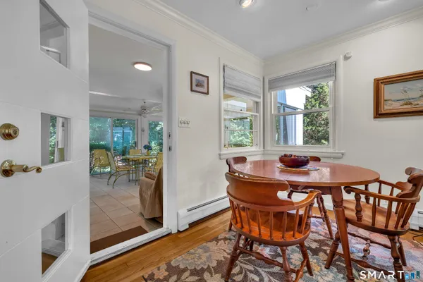 a view of a dining room with furniture and a potted plant
