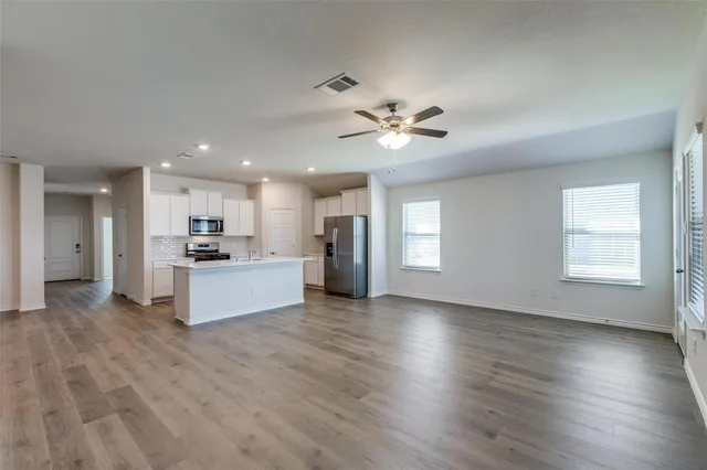 a view of kitchen with furniture and wooden floor