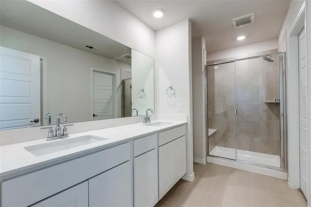 a bathroom with a shower sink and mirror