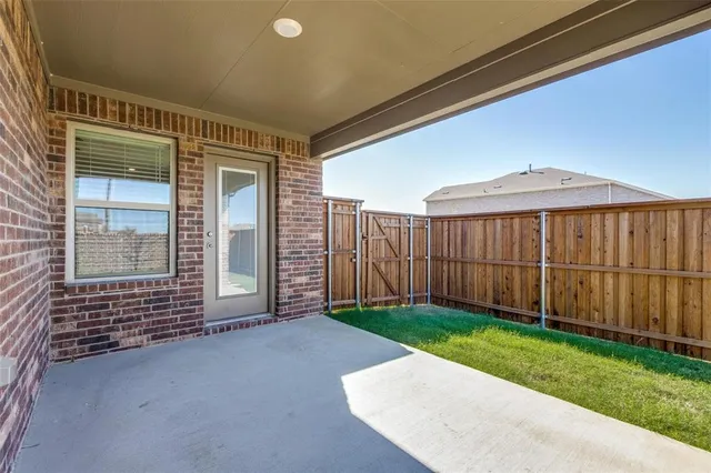 a view of a backyard with wooden fence