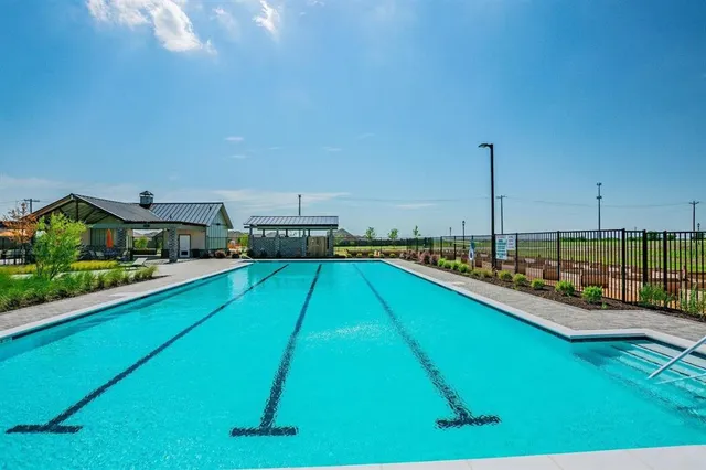 a view of a swimming pool with outdoor seating