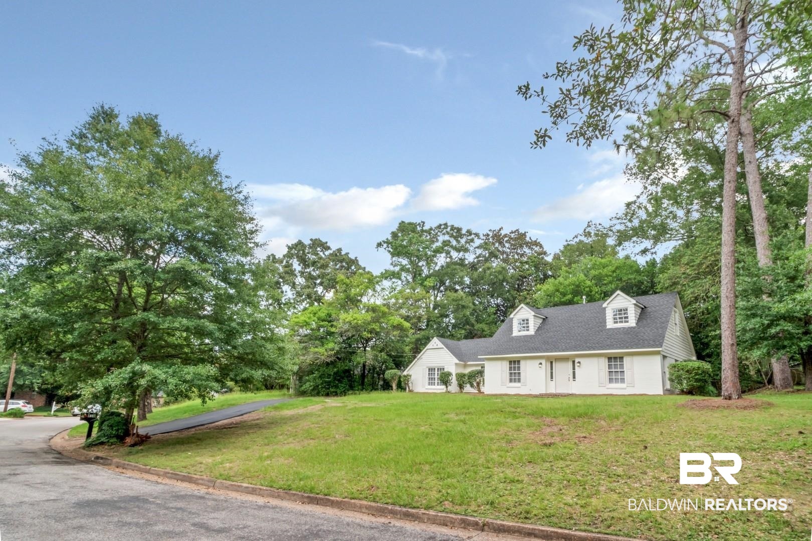 810 Nassau Drive Mobile, AL 36608 - Photo 22 of 31 Cape cod home featuring a front lawn and view of scattered trees