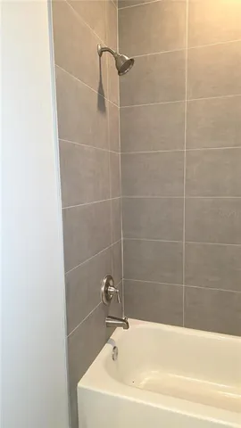 a white bath tub sitting next to a white sink