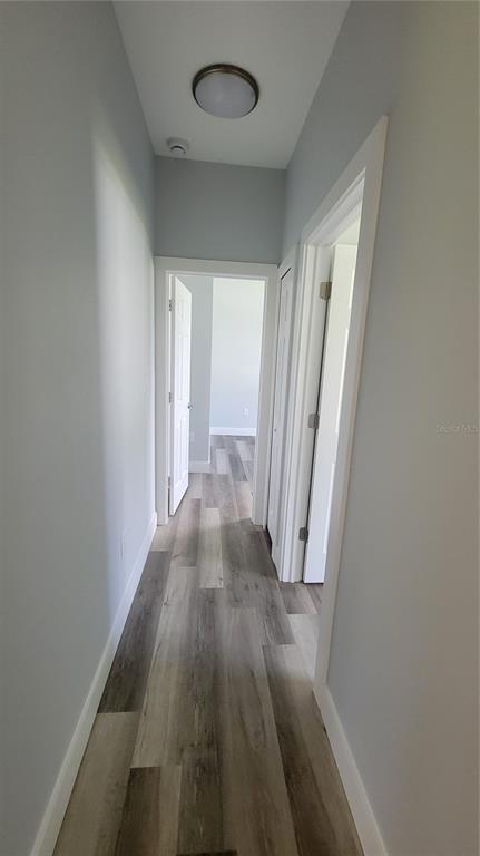 23498 Macbeth Court Punta Gorda, FL 33980 - Photo 13 of 27 wooden floor in an empty room with a window