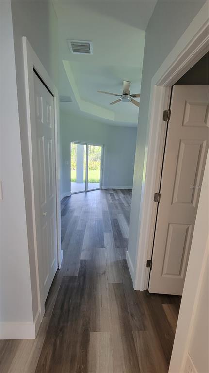 23498 Macbeth Court Punta Gorda, FL 33980 - Photo 20 of 27 an empty room with wooden floor and windows