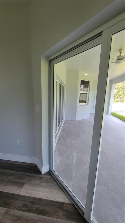 23498 Macbeth Court Punta Gorda, FL 33980 - Photo 22 of 27 a view of a hallway with wooden floor and a living room