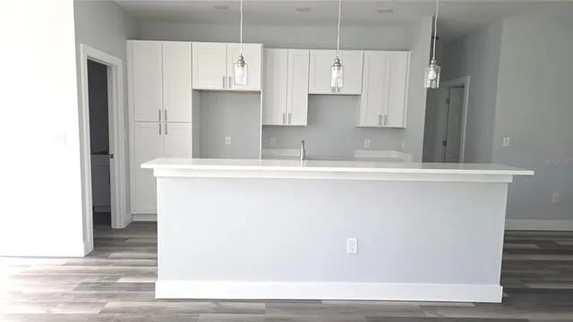 a view of a refrigerator a stove top oven with kitchen island
