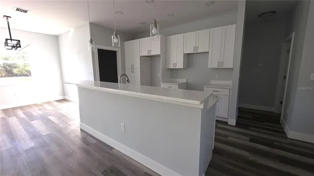 a view of a kitchen with wooden floor