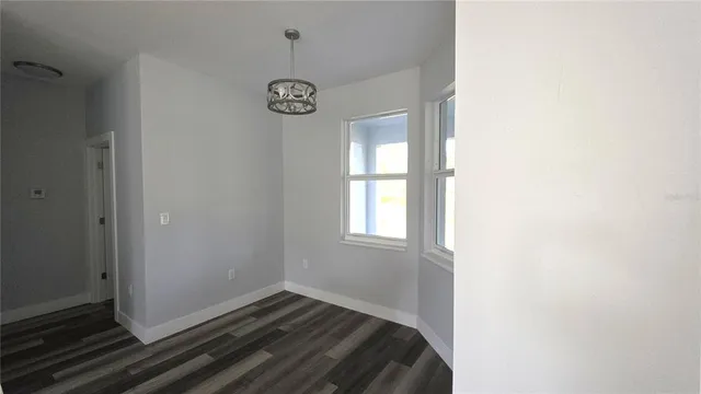 a view of bedroom with window and hardwood floor