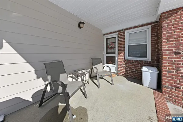 a view of a patio with table and chairs and potted plants
