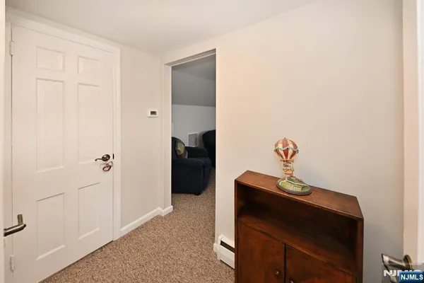 a living room with furniture a flat screen tv and kitchen view