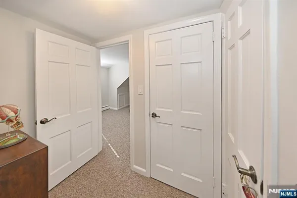 a bedroom with furniture and a flat screen tv