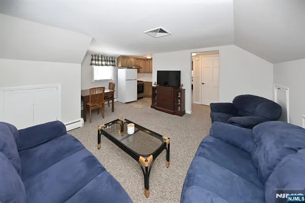a kitchen with refrigerator cabinets and a window