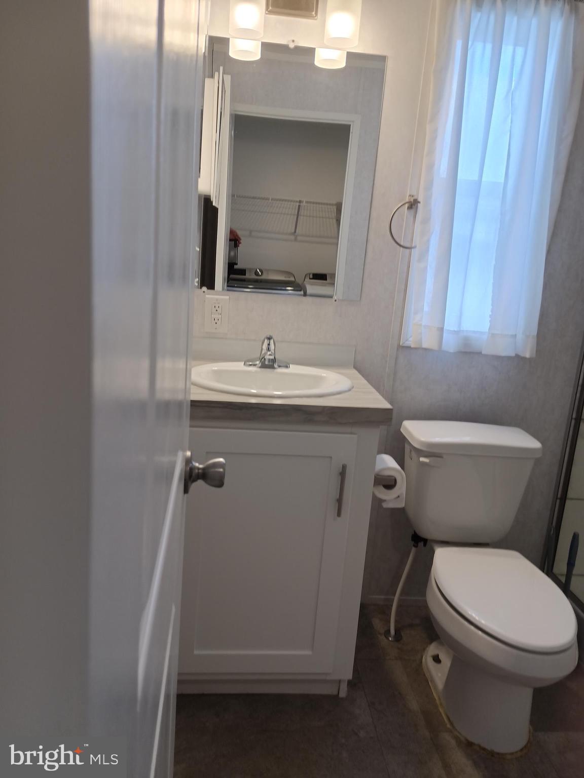 1405 Farrell Avenue, Unit 325 Cherry Hill, NJ 08002 - Photo 15 of 15 a bathroom with a toilet sink and mirror